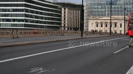 London Buses driving past on the London Bridge, United Kingdom