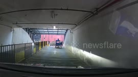 Driver reverses away as out-of-control trailer rolls backwards