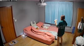 Infant wriggles in bed to copy mum's dancing