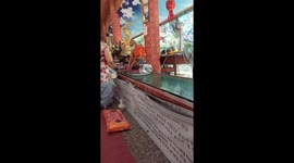 Buddhist temple uses conveyor belt to move donations