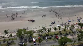 Life guards resuscitating drowning victim. With helicopter transport. On the beach in Brazil