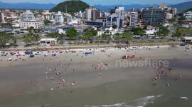 Life guards resuscitating drowning victim. With helicopter transport. On the beach in Brazil