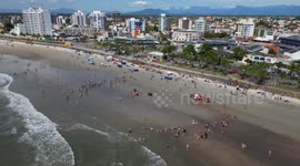 Life guards resuscitating drowning victim. With helicopter transport. On the beach in Brazil