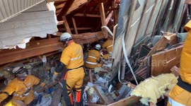Firefighters search for Japan earthquake survivors in collapsed buildings