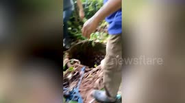 Rescue volunteers pull pet dog out of deep well