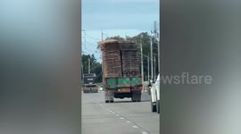 Wooden platform nearly falls from the back of overloaded truck