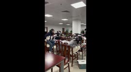 Students catch mouse in library without making a sound