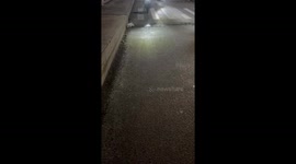 Student slides on icy road during freezing winter in China