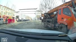 Lorry crane hits entry gate mid road causing its metal awning to fall on the cabin