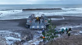 Officials transport heavy machinery by ship amid earthquake relief missions in Japan