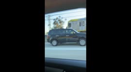 Train Hopping Fellow Waves to Traffic