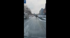 Electric bike skids and falls on icy road in China