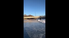 Skater staggers to ground when can't stop in frozen lake