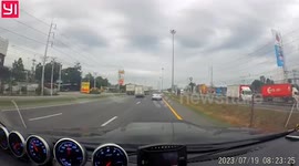 Moving car's bonnet blown open by strong winds and blocks driver's view