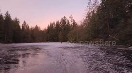 Locals ski on frozen lake despite severe weather warning in British Columbia