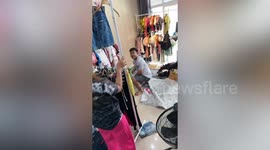 Baby monitor lizard enters clothes store caught with basket