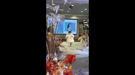 Wedding flower girl stumbles and stands to deliver couple's ring