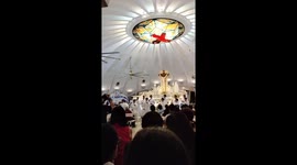 Choir boys dance during Catholic church service
