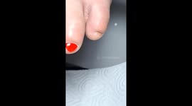 Beautician carefully paints tiny toenail