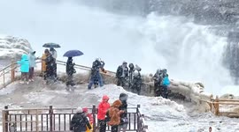 Hukou Waterfall transforms into enchanting winter wonderland in first snowfall of 2024