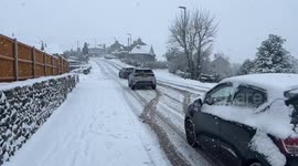 Car struggles up a snowy road conditions in the Lake District, Kendal