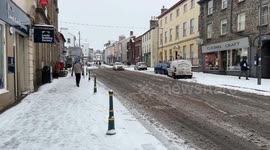 Stricklandgate in Kendal Town Centre in the Snow - shows cars and people passing in wintery conditions