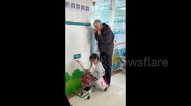Chinese Grandfather Warms IV Tube for Sick Granddaughter in Henan, China
