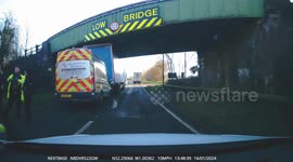 Emergency services assembled as truck gets stuck under low bridge near Northampton