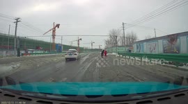 Icy water splashes onto oncoming car's windshield and obscures view