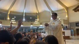 Priest pours holy water onto followers when bottle cap detaches during service in the Philippines