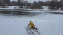 Firefighter rescues pup from frozen pond