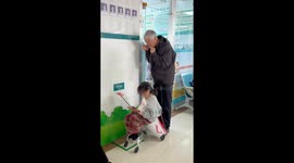 Caring grandfather warms IV tube for sick granddaughter in China