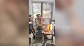 Indian cop uses heater to warm up wild monkey that ventured in from cold
