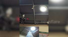 Bizarre moment man uses a drone to screw in a lightbulb