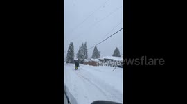 Canada: Man Skis Down Snow-Covered Street In Coquitlam, British Columbia