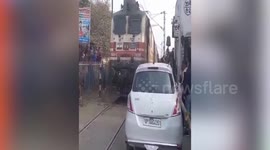 Car driver parked near rail tracks escapes death when train roars past