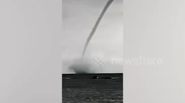 Twin waterspout tornadoes tear along coast of Indonesia