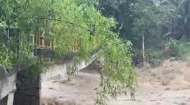 Pedestrian bridge collapses in raging floods in the Philippines