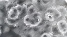 Stunning ice formations on frozen lake resemble lunar landscape