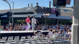 Tour Down Under cycling street party catwalk models with topless male dancers in Adelaide