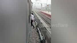 Phone thief hangs from window of moving train after being caught by passengers