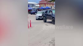 Wild python slithering on road slows down traffic being rescued by locals