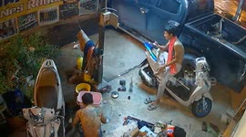Gas canister bursts into flames as mechanics fix scooter