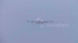 World's largest passenger plane lands in cloud of spray in Storm Jocelyn strong wind and wet weather at Birmingham Airport