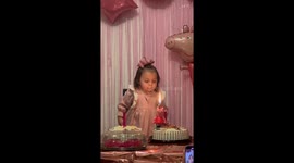 Family is hysterics as 2-year-old tries her best to blow out candle on her birthday