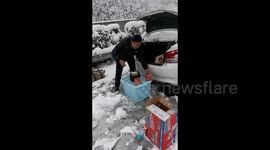 Driver stranded in snowstorm cooks noodles on Chinese highway to survive 7-hour traffic jam