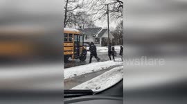 Police Officer Helps Children to Get Into School bus in Frankfort, USA