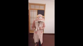 Father disguises as his wife in pink robe to cuddle baby daughter