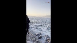 Footsteps on ice:  Girl explores the frozen beauty of Lake Balaton