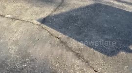 Dad makes incredible trick football shot, throwing it into swing at park